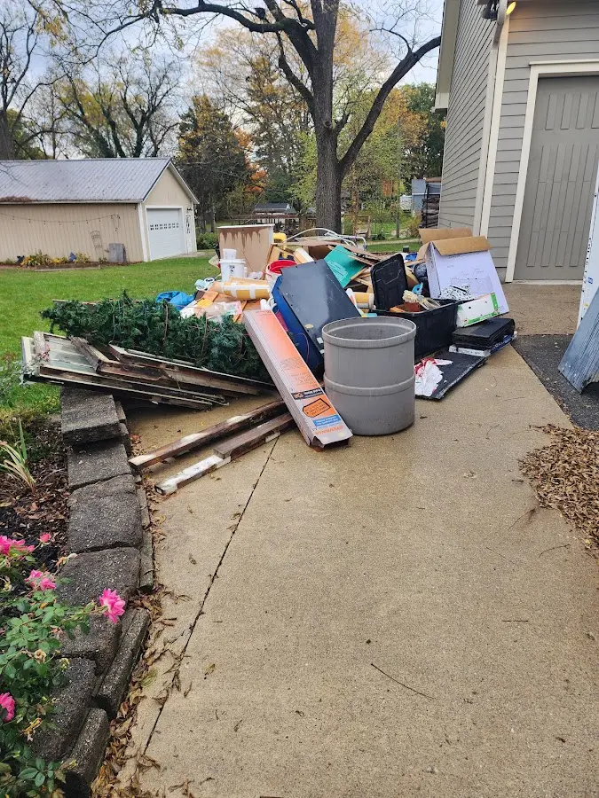 Dumpster being loaded with debris for Estate Cleanout Dumpster Rental in Woodstock